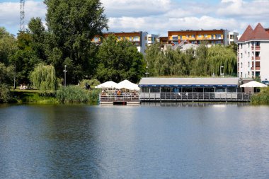 Warsaw, Poland - August 7, 2022: Overall view of the multi-storey residential buildings by the park and lake in the Goclaw estate, in the Praga Poludnie district.