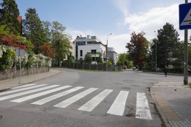 Gdynia, Poland - May 30, 2022: Streets with no traffic in a quiet residential area, and you can see a pedestrian crossing on one of these streets.