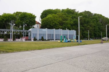 Gdynia, Poland - May 25, 2022: The rather small building with a modern glass facade houses a restaurant and is situated along the city's seafront boulevard