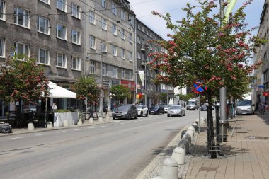 Gdynia, Poland - May 30, 2022: A row of multi-story, multi-family residential buildings along the high street leading through the city. There is little traffic now