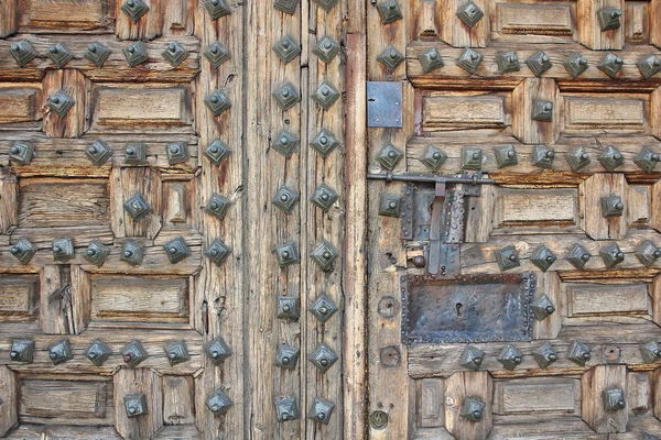 Old wooden door with nails — Stock Photo, Image