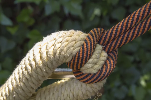 Macro of red rope with yellow rope knot — Stock Photo, Image