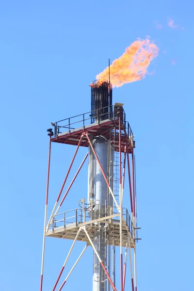 Chimneys of a refinery of oil with large flares — Stock Photo, Image