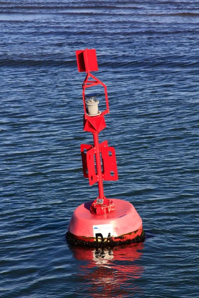 A buoy marker in a channel aids navigation of boats — Stock Photo, Image