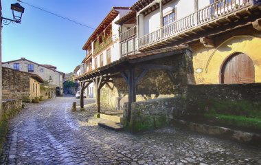 Streets typical of old world heritage village of Santillana del clipart