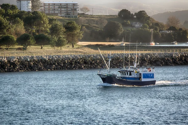 Lilla fishing båt seglar utmed kusten i ett blått hav — Stockfoto