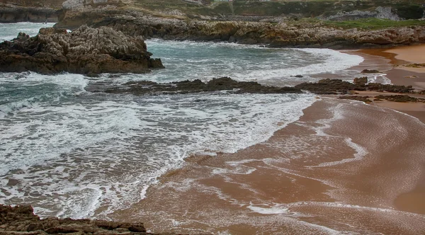 Costa con olas rompiendo en un día tormentoso — Foto de Stock