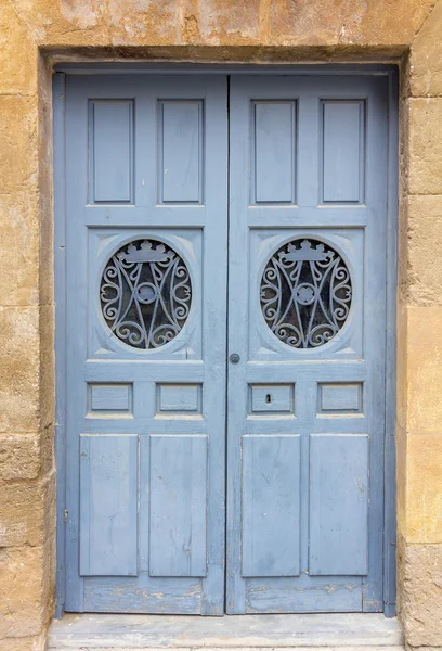 wooden door painted blue and decorated