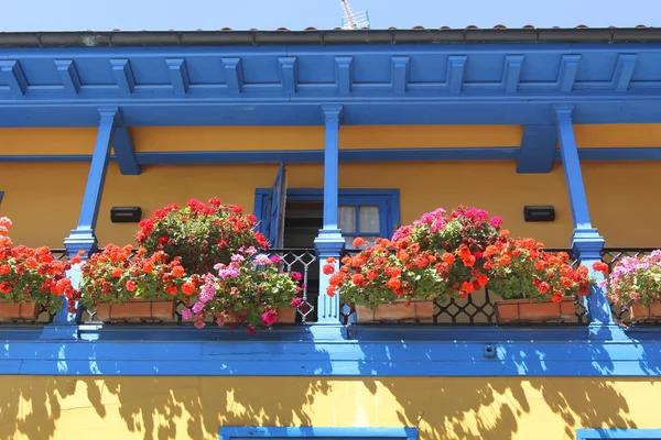 Buntes Haus mit Balkon voller Blumen — Stockfoto