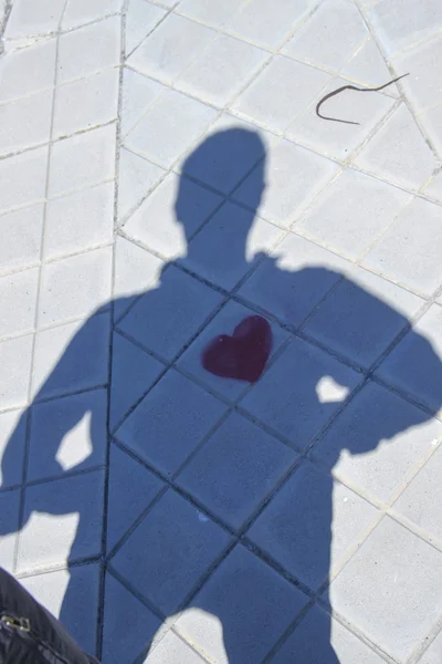 Shadow of a person with a heart painted on the floor — Stock Photo, Image