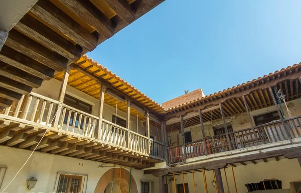 Spanish beautiful old building with white walls and wooden decki — Stock Photo, Image