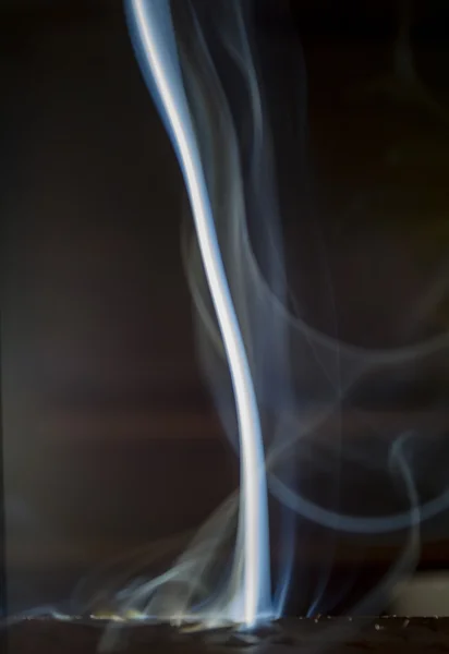 Smoke of incense aromatic creating forms on a black background — Stock Photo, Image