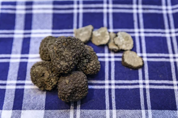 Whole and sliced black truffles at a shop in San Sebastian, Basque Country Spain — Stock Photo, Image