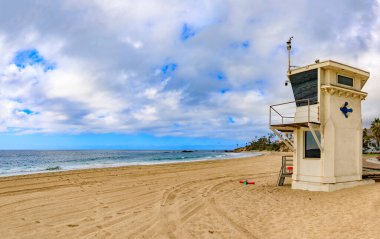 Vintage lifeguard station in Laguna Beach, famous tourist destination in California, Pacific Ocean in the background a on a cloudy day