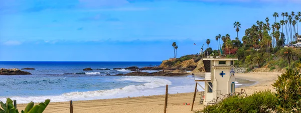 Beach and Pacific ocean in Laguna Beach, famous tourist destination in California, USA with a lifeguard station on a cloudy day