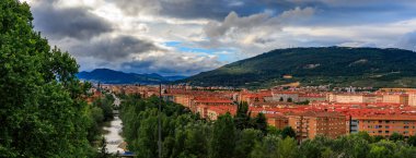 Landscape with a view of a valley and the Pyrenees mountains in the suburbs of Pamplona, Navarre, Spain on a cloudy day