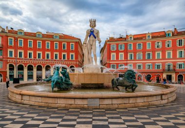 Nice, France - May 25 2022: Statue of Apollo with a blue awareness ribbon in support against multiple sclerosis at Fountain du Soleil on Place Massena