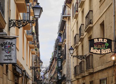 San Sebastian, Spain - June 25, 2021: Basque restaurants and bars famous for pintxos or tapas in the narrow streets, old town Donostia, Basque Country