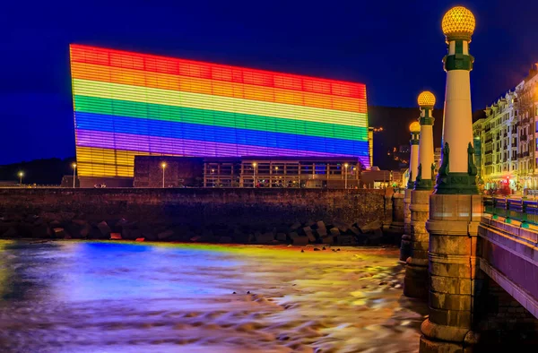 San Sebastian skyline with Kursaal Congress Centre and Auditorium conference center in Spain, decorated with an LGBT Pride rainbow flag at sunset