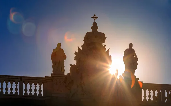 Sunset view of the ornate baroque architecture of the Royal Palace or Palacio Real viewed from Plaza de Oriente in Madrid, Spain