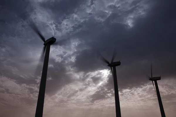 Aerogenerator windmills on dramatic sunset sky — Stock Photo, Image