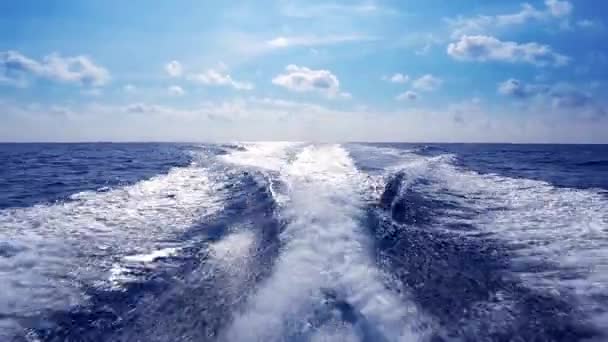 Blue ocean sea with fast yacht boat wake foam of prop wash