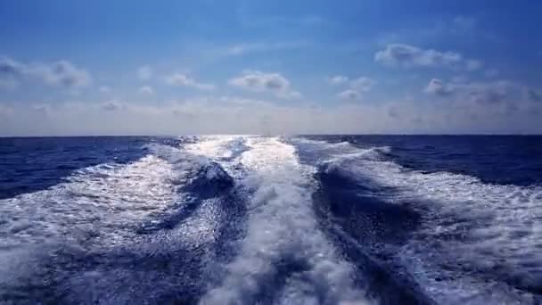 Blue ocean sea with fast yacht boat wake foam of prop wash — Stock Video