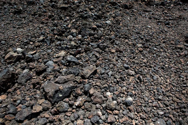 Textura půdy černé vulkanické kameny — Stock fotografie