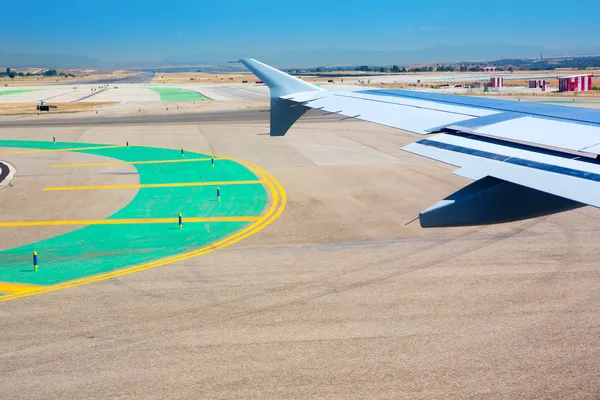 Airplane wing leaving the airport — Stock Photo, Image