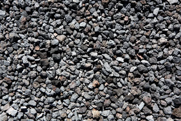 Zwarte vulkanische lavastenen patroon textuur — Stockfoto