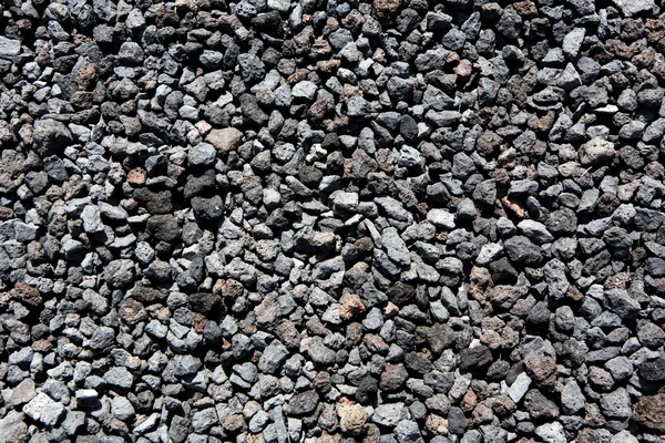 Piedras de lava volcánica negra textura patrón — Foto de Stock