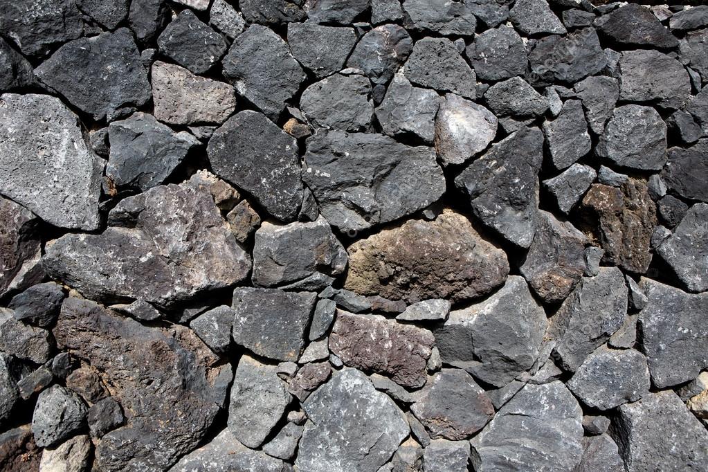 Black lava stone volcanic masonry wall Stock Photo by ©lunamarina 13306413