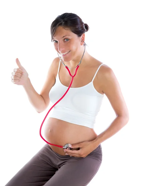 Beautiful pregnant woman as self doctor with stethoscope Stock Photo