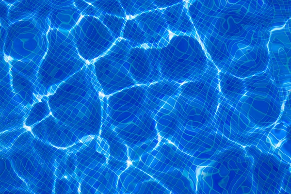 Blauwe tiels zwembad met rimpel water reflectie — Stockfoto