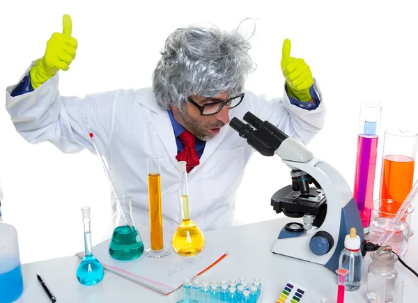 Crazy mad nerd scientist at laboratory microscope — Stock Photo, Image