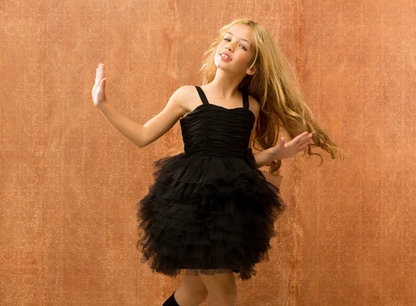 Black dress kid girl dancing and twisting vintage — Stock Photo, Image