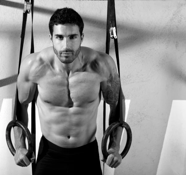 Crossfit dip ring man relaxed after workout at gym Stock Photo by