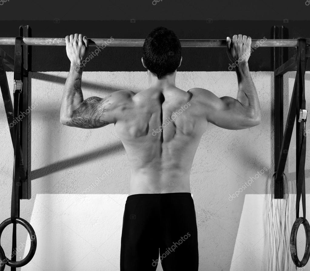 Crossfit toes to bar man pullups 2 bars workout Stock Photo by