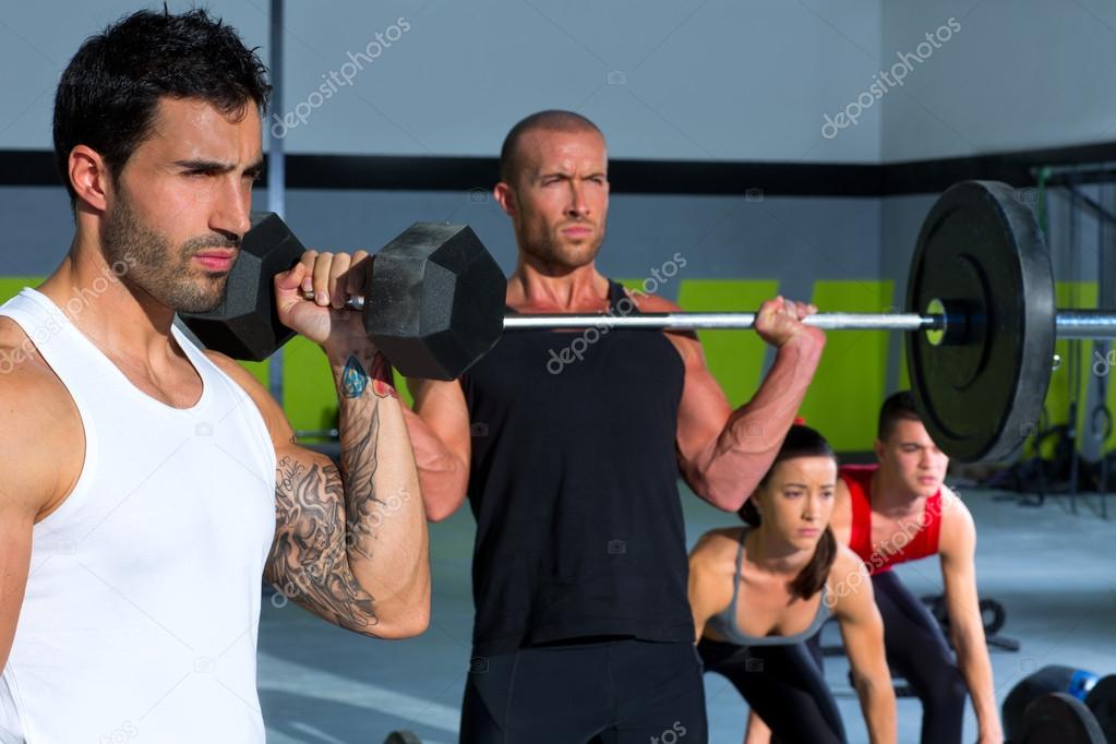 gym group with weight lifting bar crossfit workout