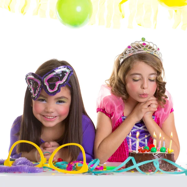 Children happy girls blowing birthday party cake — Stock Photo, Image