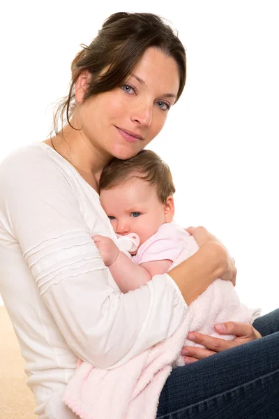 Baby girl relaxed with pacifier hug in mother arms — Stock Photo, Image