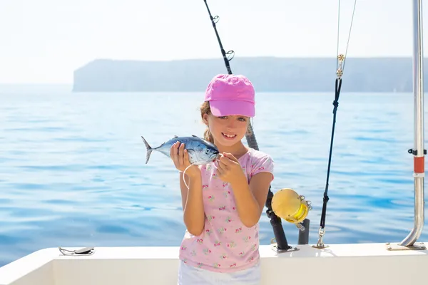 Child little girl fishing in boat holding little tunny fish catc — Stock Photo, Image