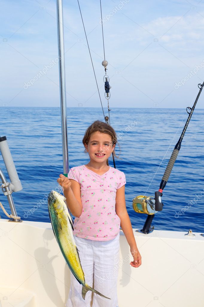 child girl fishing in boat with mahi mahi dorado fish catch