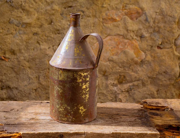 Antique rusted iron jar with aged brass on vintage wood — Stock Photo, Image