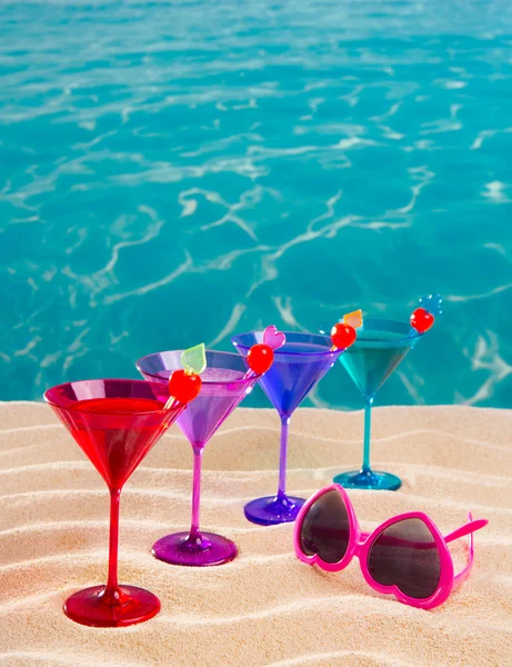 Colorful cocktail in a row with cherry on tropical sand beach — Stock Photo, Image