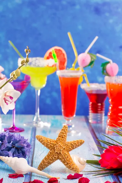 Colorful mixed cocktails in tropical blue wood — Stock Photo, Image