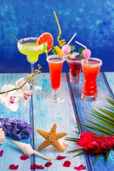 colorful mixed cocktails in tropical blue wood