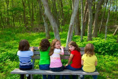 Forest park bankta oturan çocuk kız kardeşi ve arkadaşı kızlar