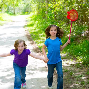 Friends and sister girls running in the forest track happy clipart