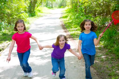 Friends and sister girls running in the forest track happy clipart